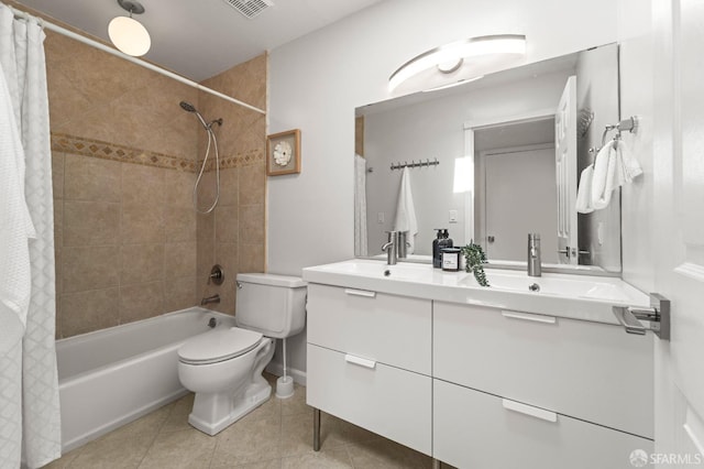 bathroom featuring tile patterned floors, shower / bath combo, toilet, and vanity