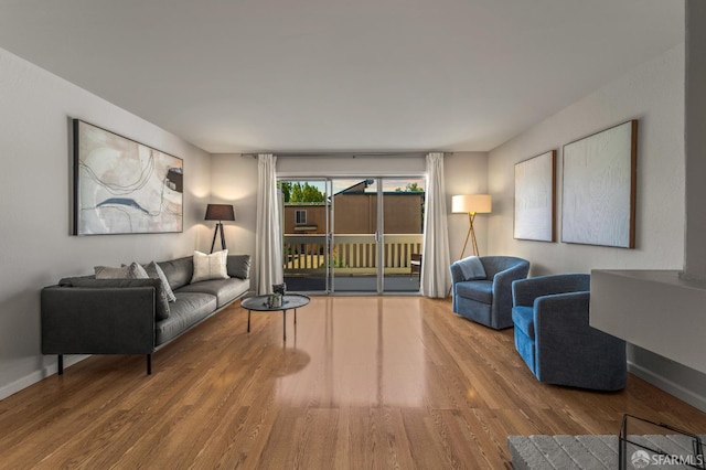 living area with wood finished floors and baseboards