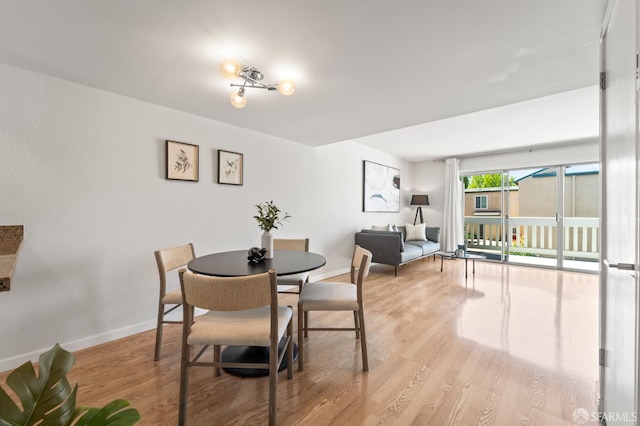 dining area featuring wood finished floors and baseboards