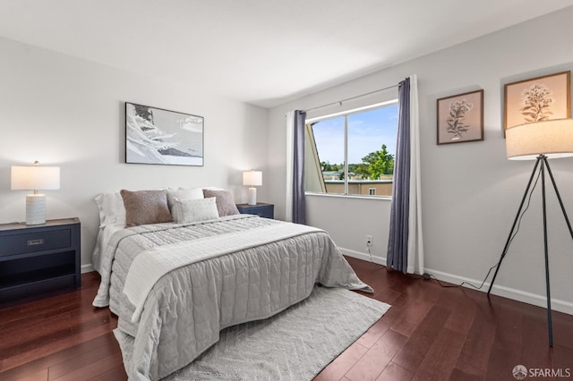 bedroom featuring wood finished floors and baseboards