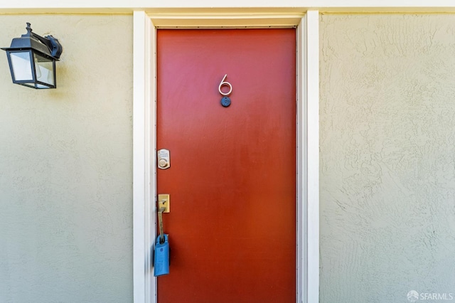 property entrance featuring stucco siding