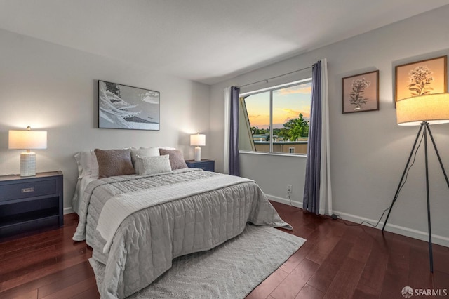 bedroom featuring wood finished floors and baseboards