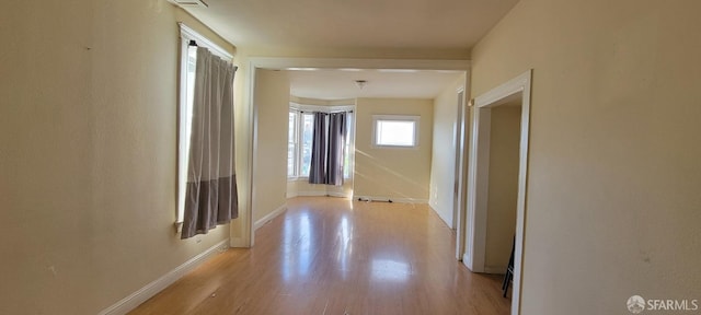 hallway with light hardwood / wood-style flooring