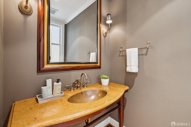 bathroom featuring vanity, crown molding, and visible vents