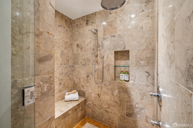 bathroom with tiled shower