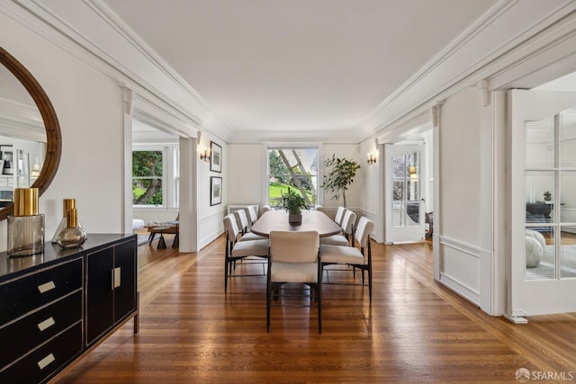 dining space with dark wood-type flooring and ornamental molding