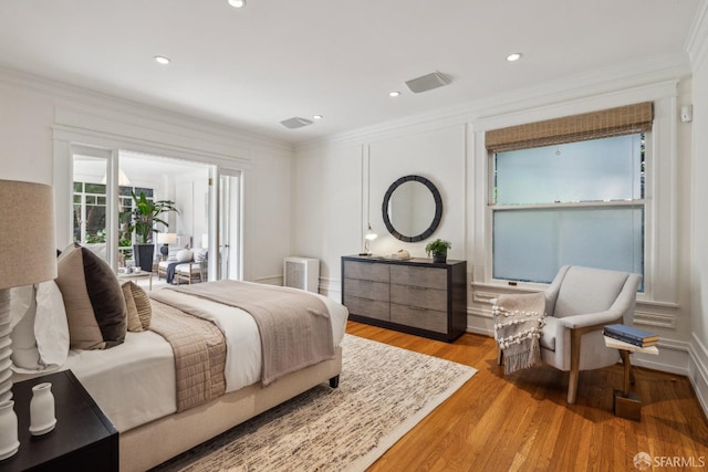 bedroom with recessed lighting, wood finished floors, and crown molding