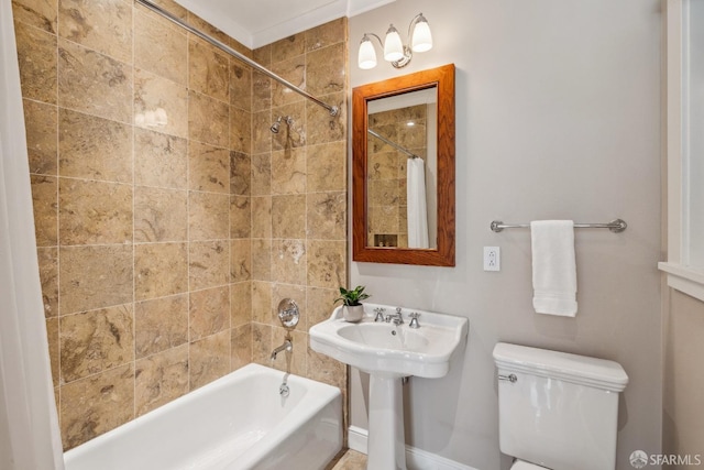 full bathroom featuring a sink, toilet, and shower / bath combination with curtain