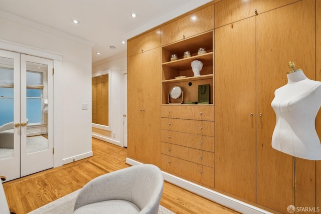 interior space with baseboards, light wood-type flooring, ornamental molding, recessed lighting, and french doors