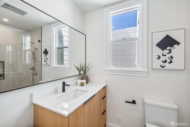 bathroom with vanity, toilet, and an enclosed shower