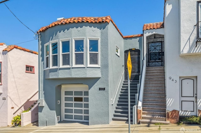 rear view of property featuring a garage