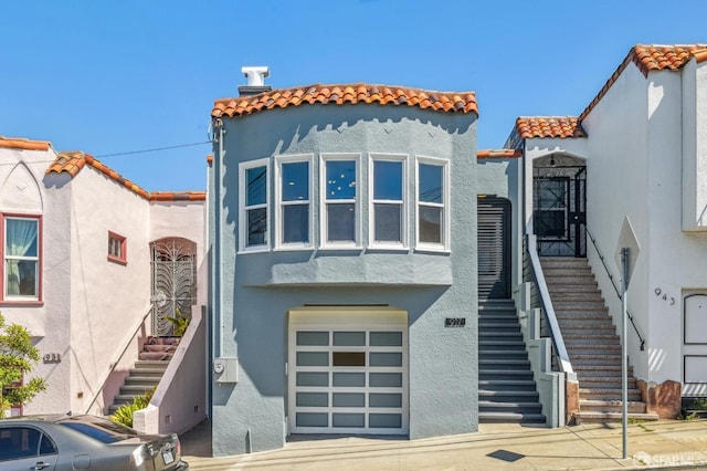 mediterranean / spanish home featuring a garage