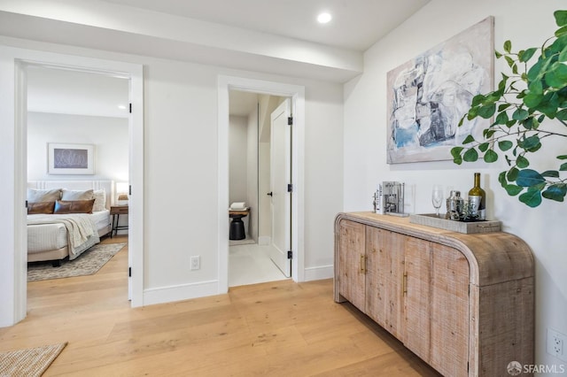 hallway with light hardwood / wood-style floors