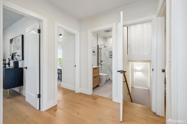 hall with light hardwood / wood-style floors