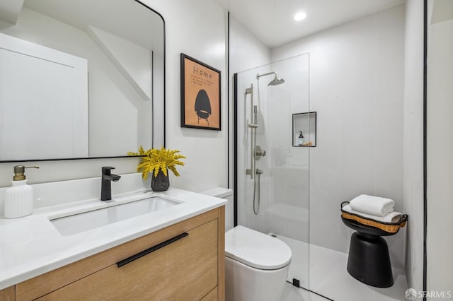 bathroom with vanity, toilet, and a shower with shower door