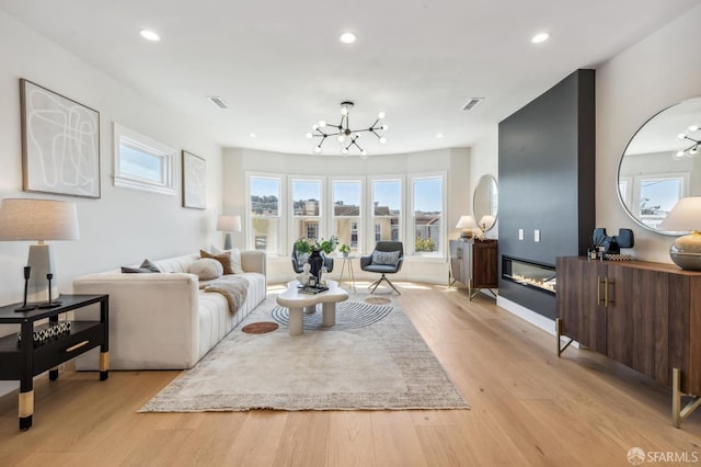 living room featuring light hardwood / wood-style floors and a chandelier