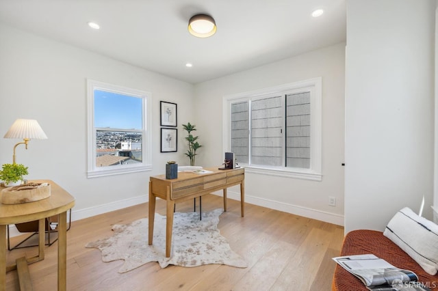 office area with light hardwood / wood-style floors