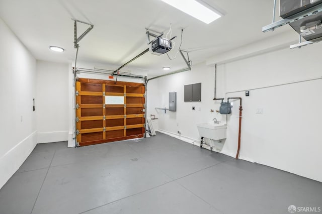 garage featuring a garage door opener, electric panel, and sink