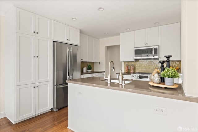 3044 Franklin St Unit 302, San Francisco, CA 94123 - kitchen featuring appliances with stainless steel finishes, a peninsula, white cabinetry, a sink, and recessed lighting