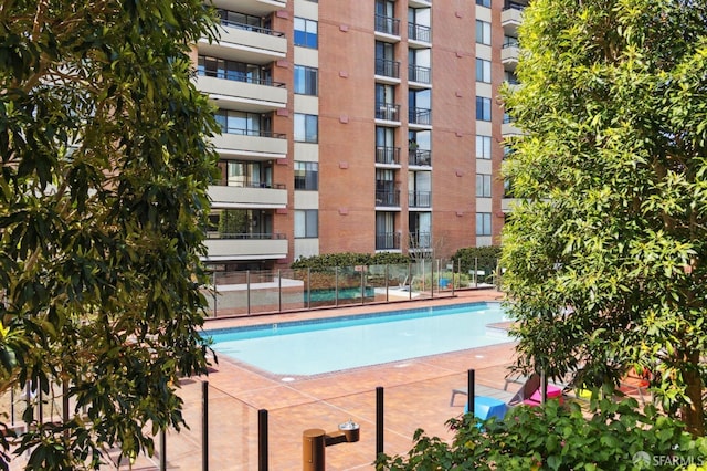 view of swimming pool with fence