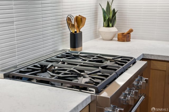 102 Baker St Unit B, San Francisco, CA 94117 - kitchen view of stainless steel range with gas stovetop, brown cabinets, and light countertops