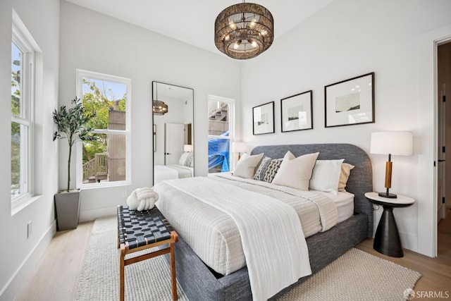 102 Baker St Unit B, San Francisco, CA 94117 - bedroom featuring a chandelier and wood finished floors