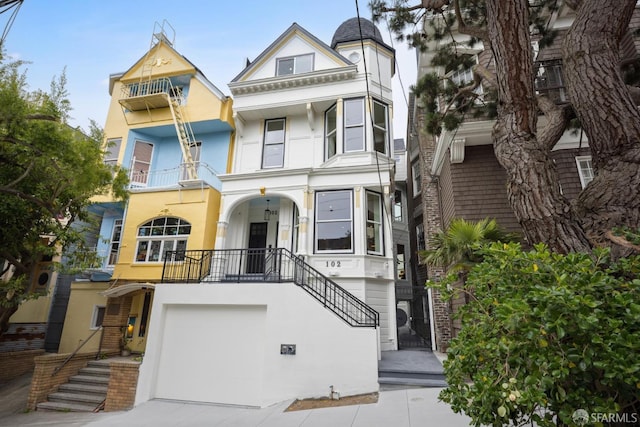 102 Baker St Unit B, San Francisco, CA 94117 - view of front of property with stucco siding, an attached garage, stairs, and concrete driveway