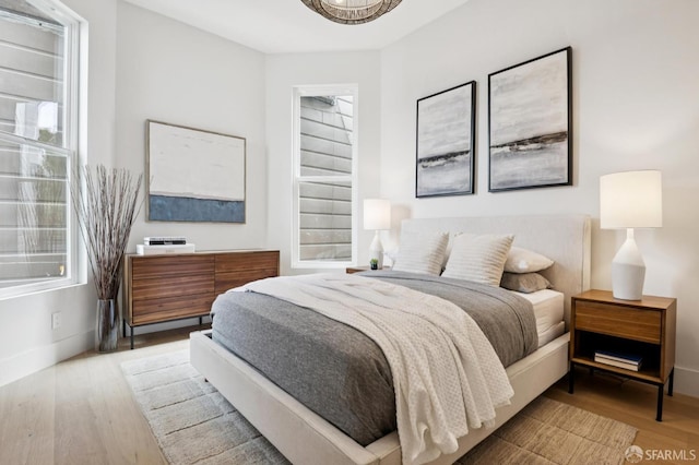 102 Baker St Unit B, San Francisco, CA 94117 - bedroom with multiple windows and wood finished floors