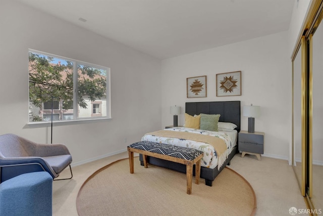 carpeted bedroom with a closet and baseboards