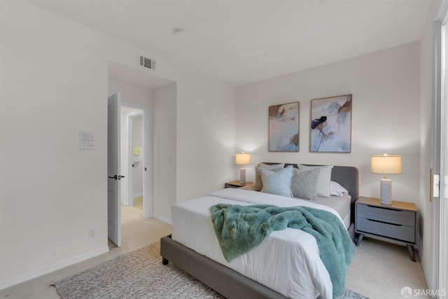 bedroom with visible vents, light colored carpet, and baseboards