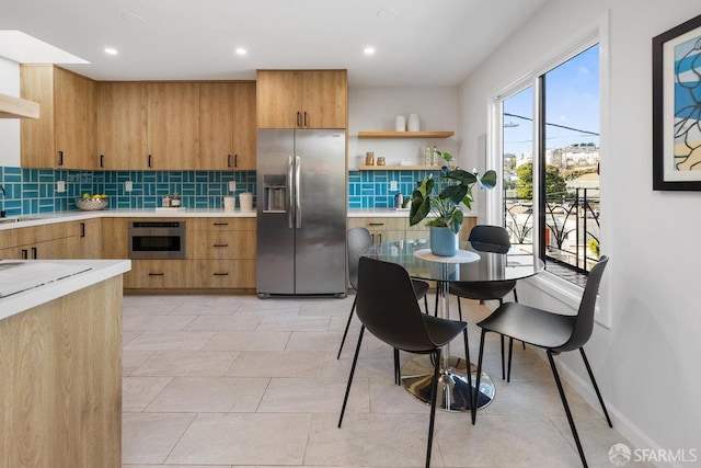 kitchen with appliances with stainless steel finishes and decorative backsplash