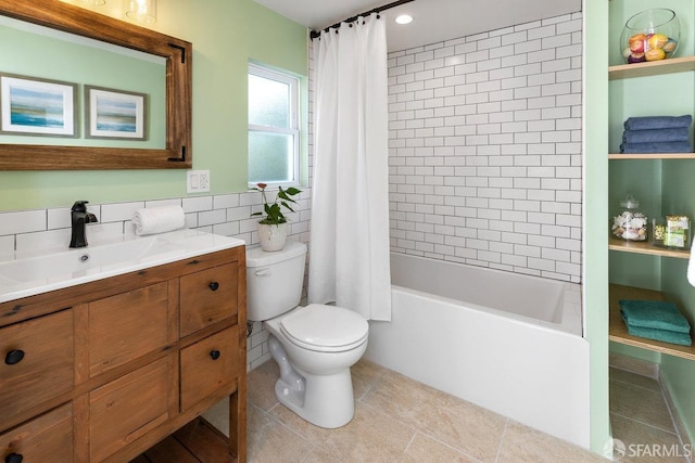 full bathroom with tile walls, shower / bath combination with curtain, tile patterned flooring, vanity, and toilet