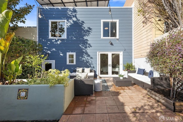 back of house featuring an outdoor living space, a patio, and french doors