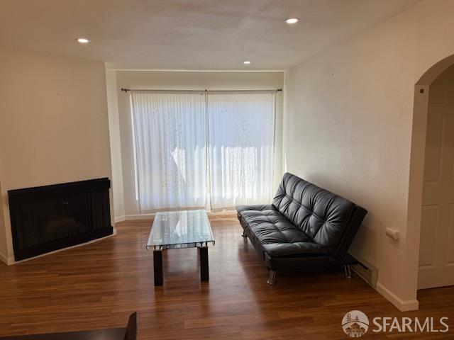 397 Imperial Way Unit 306, Daly City, CA 94015 - sitting room with arched walkways, baseboards, recessed lighting, and wood finished floors