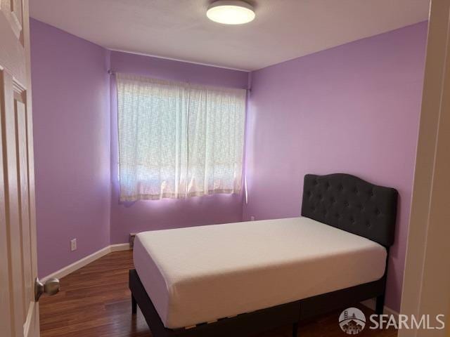 397 Imperial Way Unit 306, Daly City, CA 94015 - bedroom with baseboards and dark wood-style flooring