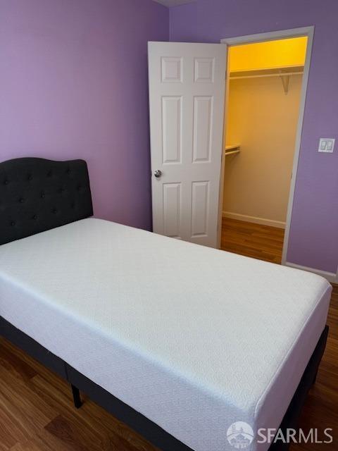 397 Imperial Way Unit 306, Daly City, CA 94015 - bedroom featuring baseboards, wood finished floors, and a spacious closet