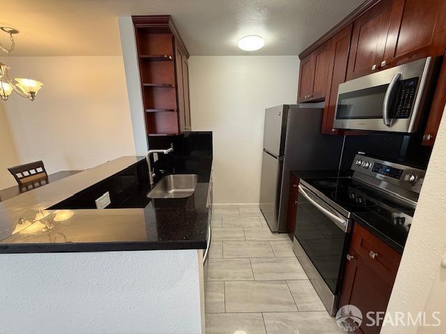 397 Imperial Way Unit 306, Daly City, CA 94015 - kitchen featuring open shelves, dark countertops, a chandelier, a sink, and appliances with stainless steel finishes