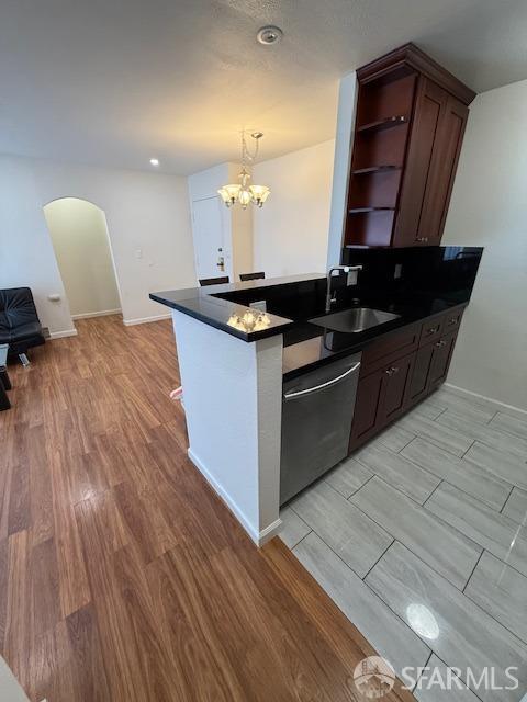 397 Imperial Way Unit 306, Daly City, CA 94015 - kitchen with dark countertops, arched walkways, open shelves, dishwasher, and a sink