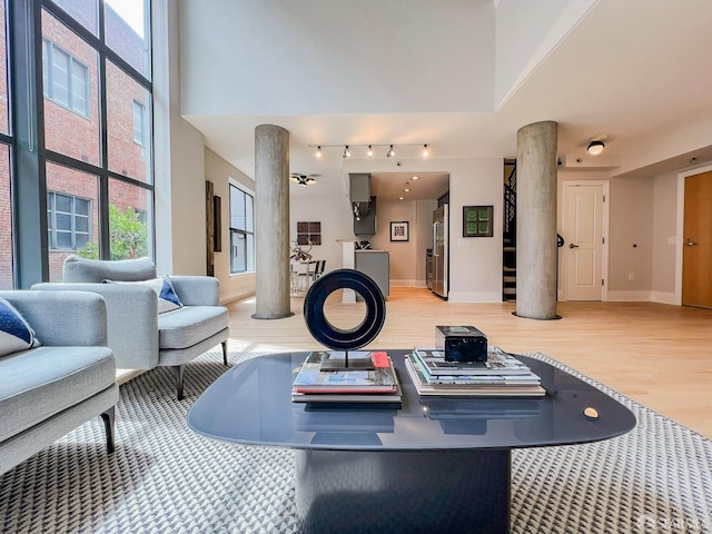 1 Bluxome St Unit 317, San Francisco, CA 94107 - exercise room featuring ornate columns, wood finished floors, and a high ceiling