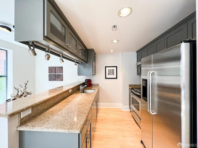 1 Bluxome St Unit 317, San Francisco, CA 94107 - kitchen featuring appliances with stainless steel finishes, light wood-style floors, a peninsula, recessed lighting, and light stone counters