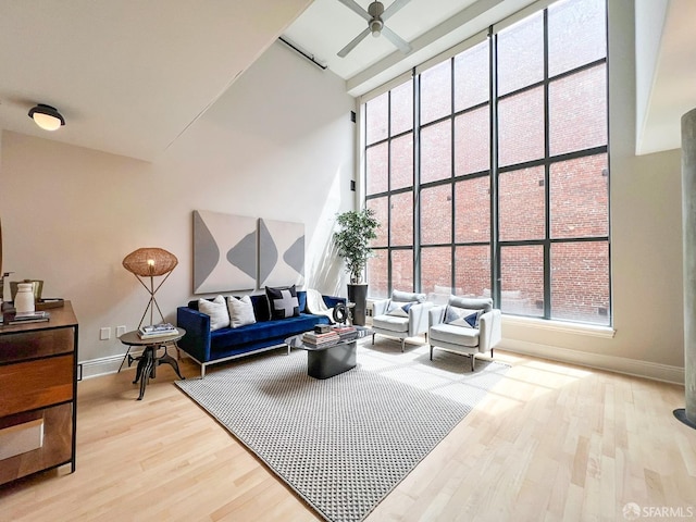 1 Bluxome St Unit 317, San Francisco, CA 94107 - living room featuring a towering ceiling, a ceiling fan, healthy amount of natural light, and wood finished floors
