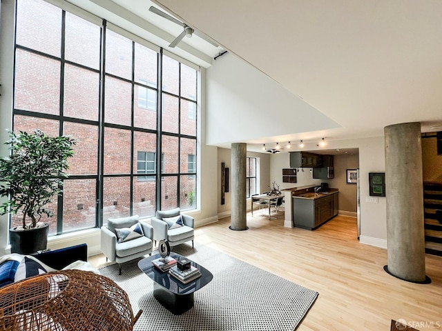 1 Bluxome St Unit 317, San Francisco, CA 94107 - living area featuring a towering ceiling, light wood finished floors, and stairway