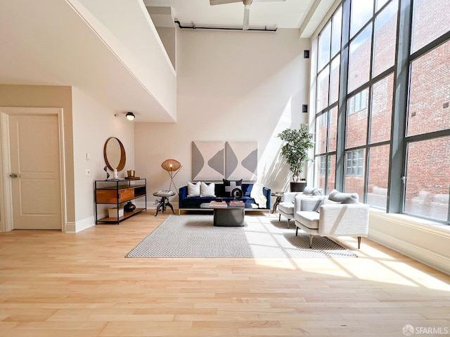 1 Bluxome St Unit 317, San Francisco, CA 94107 - living room with a high ceiling, wood finished floors, and ceiling fan