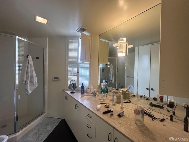 full bathroom featuring a shower stall and vanity