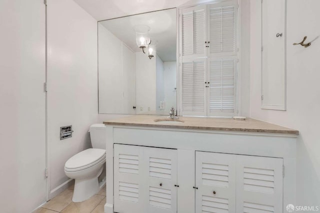 bathroom with vanity, tile patterned flooring, and toilet