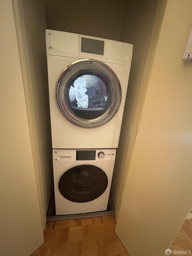 clothes washing area with stacked washer / drying machine
