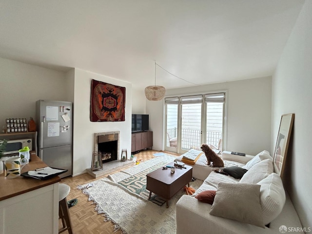 living area featuring a high end fireplace