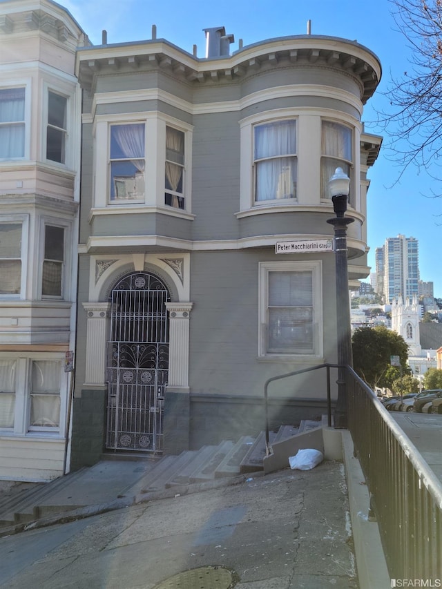 view of front of house featuring fence and a gate