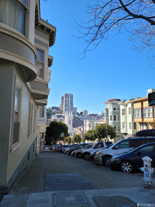 uncovered parking lot featuring a city view