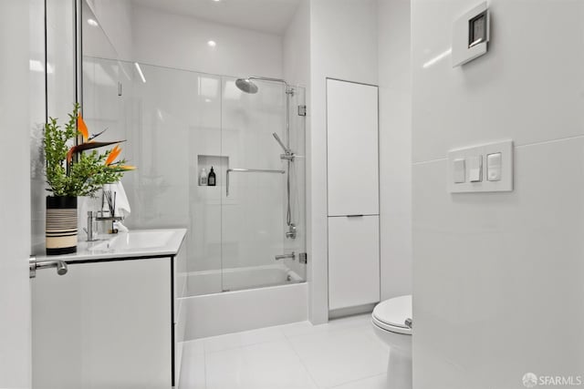 full bathroom with tile patterned flooring, vanity, toilet, and bath / shower combo with glass door